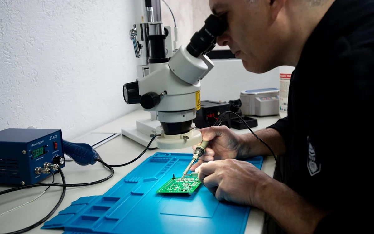 Inspección de una placa con lupa binocular en el laboratorio de Greenlabs